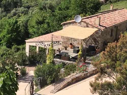 a house with a gazebo in a garden at Gîte A Funtana Montestremo, Balagne, Haute Corse in Manso