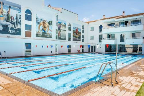a large swimming pool in a building at Hoposa Hotel & Apartaments VillaConcha in Port de Pollensa
