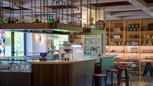 a bar in a restaurant with bar stools at San Paolo Hotel in Montegiorgio