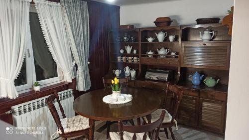 a dining room with a table and some chairs at Kuća Donji Park in Bečej