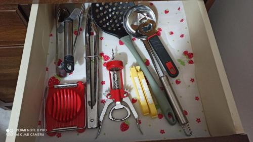 a box with a variety of kitchen utensils in it at Kuća Donji Park in Bečej