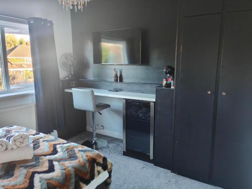 a bedroom with a bed and a sink and a desk at City Centre Room in Chester