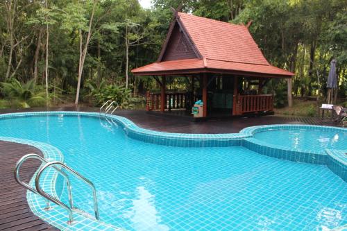 a large swimming pool with a gazebo in a resort at Marisa Resort & Spa Chiang Dao in Ban Muang Ngai