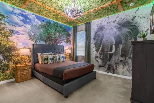 a bedroom with an elephant mural on the wall at 5BR Family Home with Pool & Hot Tub Near Disney in Kissimmee