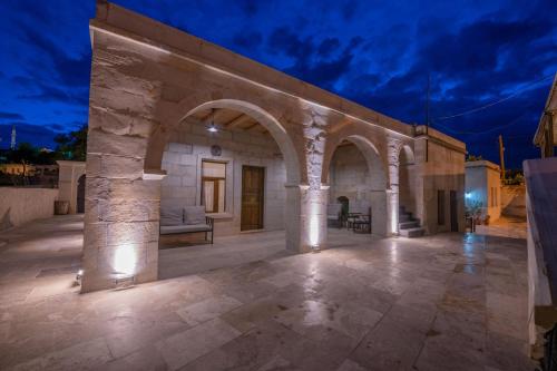 a stone building with a patio at night at Asyada Suites Hotel in Nevsehir