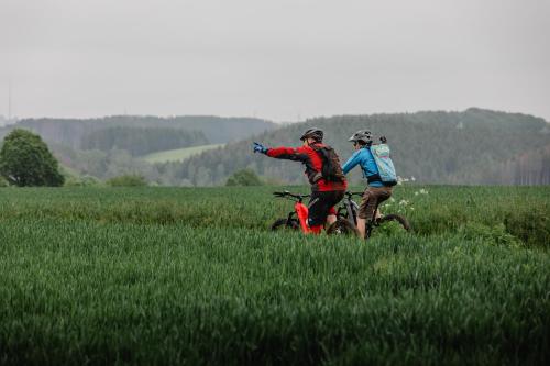 a group of people on bikes in a field at Koener Hotel & Spa in Clervaux