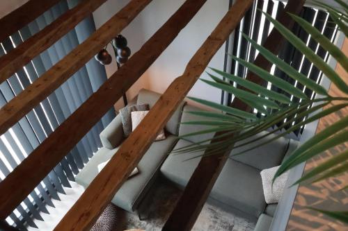 a staircase with wooden rails and a plant at Maas & Me in Dilsen-Stokkem