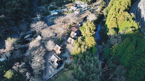 an aerial view of a house with trees and a river at MARUTA 和歌山すさみ in Susami