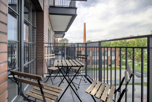 a balcony with a table and chairs on a balcony at AboutArtApartments - By the river in Wrocław