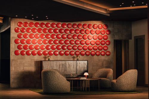 a wall with a painting of red and red balls at Aethos Monterosa in Champoluc