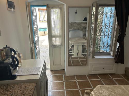 a kitchen with a door open to a room with a table at 8 oDa Marmaris in Marmaris