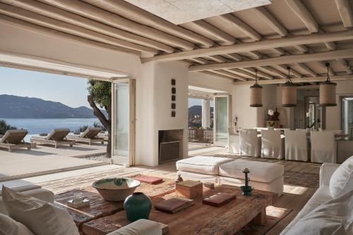 a living room with a couch and a table at Greece Dream Holidays Villas 2 in Agios Sostis Mykonos