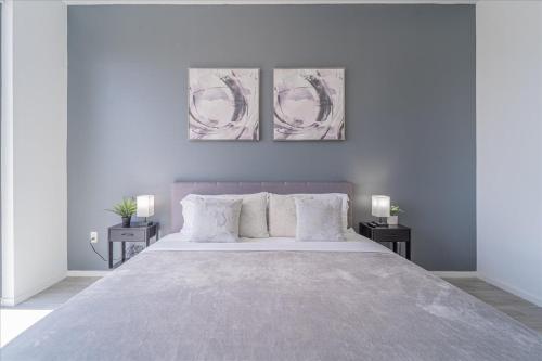 a bedroom with a large bed with three paintings on the wall at TR Miami 2 Bedroom, 1 Bedroom, and Studio Condos with Balconies in Miami
