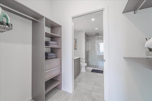 a bathroom with a walk in closet with a toilet at TR Miami 2 Bedroom Condo and Studio with Balcony in Miami