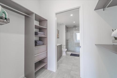 a bathroom with a walk in closet with a toilet at TR Miami 2 Bedroom, 1 Bedroom, and Studio Condos with Balconies in Miami