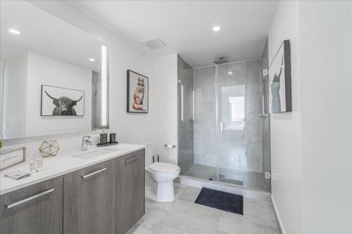 a bathroom with a toilet and a glass shower at TR Miami 2 Bedroom, 1 Bedroom, and Studio Condos with Balconies in Miami