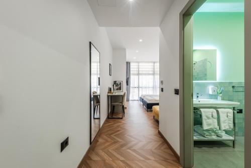 a bathroom and a bedroom with a sink and a mirror at Polifonia City Loft - Hotel rooms Vlorë, Albania in Vlorë