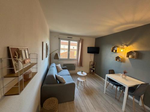 un salon avec un canapé et une table dans l'établissement Au cocon du palais, à Avignon