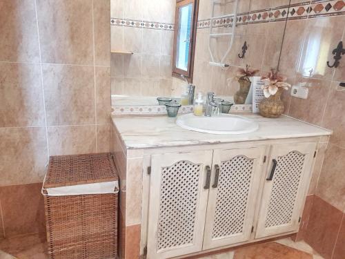 a bathroom with a sink and a mirror at 5 bedrooms villa at Sant Josep de sa Talaia 900 m away from the beach with sea view private pool and enclosed garden in Sant Josep de Sa Talaia