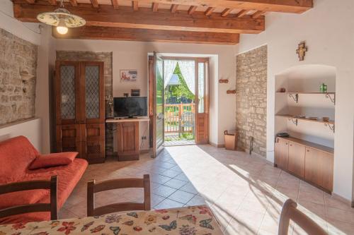 a kitchen and living room with a couch and a table at Domus Laetitiae Santa Croce in Gualdo Tadino