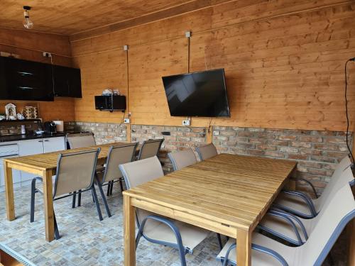 a kitchen and dining room with a wooden table and chairs at Ionela in Eforie Nord