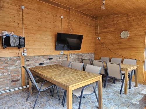 a room with a table and chairs and a tv at Ionela in Eforie Nord
