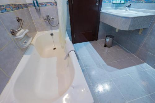 a bathroom with a toilet and a sink at Fortune Pearl Hotel in Dubai