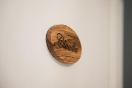 a wooden heart hanging on a white wall at La Martina Home in Valguarnera Caropepe