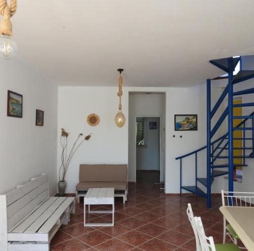a living room with benches and a blue staircase at Riviera Beach Hotel in Sozopol