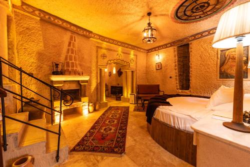 a bedroom with a bed and a staircase in a room at Utopia Cave Cappadocia in Urgup