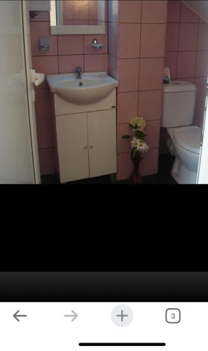 a bathroom with a sink and a toilet at Riviera Beach Hotel in Sozopol