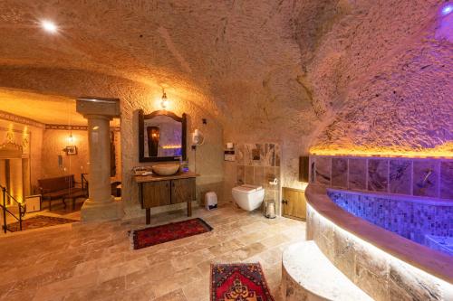 a large bathroom with a tub and a sink at Utopia Cave Cappadocia in Urgup
