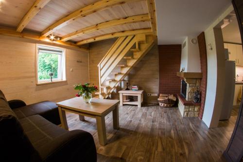 a living room with a couch and a table at Siedlisko Basiówka in Alfredówka