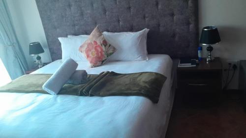 a bed in a hotel room with a woman on it at Royal Guesthouse in Mtunzini