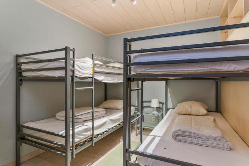 a room with three bunk beds in it at Markt 28 Glvls in Wenduine