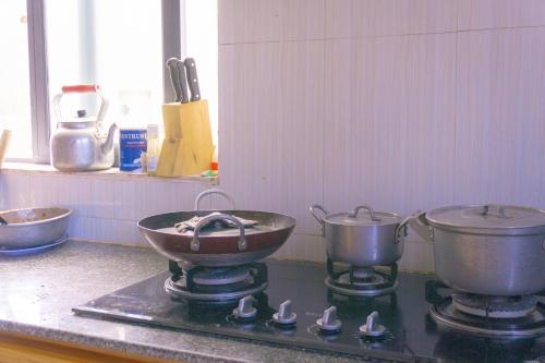 two pots and pans on a stove in a kitchen at Khách Sạn An Bình Đảo Phú Quý in Phú Quý