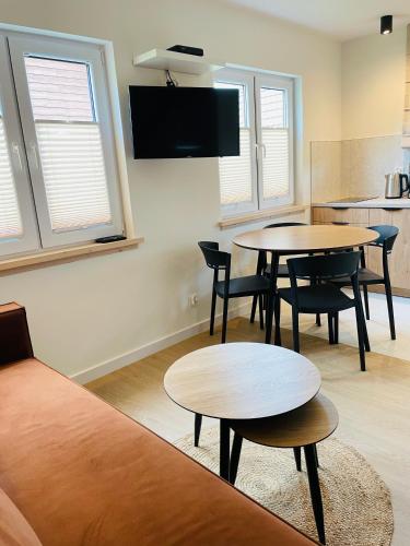 a living room with two tables and a couch at RESET INN in Zawóz