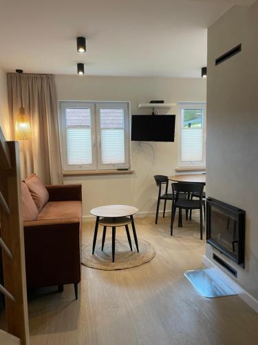 a living room with a couch and a table at RESET INN in Zawóz