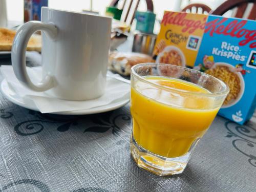 a glass of orange juice next to a cup of coffee at Burlington West hotel in Blackpool