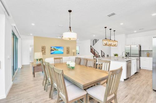 a dining room and kitchen with a table and chairs at Stunning 9BR Home - Family Resort with Private Pool, Hot Tub, Games room and BBQ! in Kissimmee