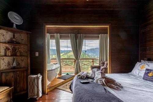 Postel nebo postele na pokoji v ubytování CHALÉ DO CAPITÃO com Hidro - URUBICI