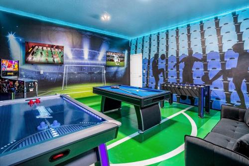 a game room with a pool table and a ping pong ball at Family Resort - 12BR Mansion - Sleeps 28 - Private Pool, BBQ and Games Room! in Kissimmee