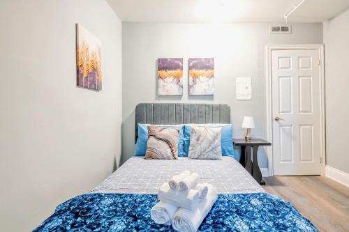 Schlafzimmer mit einem Kingsize-Bett und blauer Bettwäsche in der Unterkunft Corktown Apartment on James St South in Hamilton
