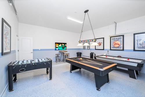 a room with two pool tables and a ping pong table at Near Disney - 12BR Home - Private Pool and Hot Tub in Kissimmee