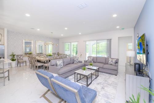a living room with a couch and a table at Near Disney - 12BR Home - Private Pool and Hot Tub in Kissimmee