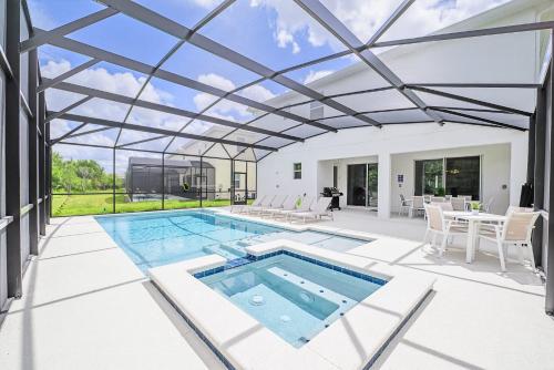 a swimming pool with a pergola on a house at Near Disney - 12BR Home - Private Pool and Hot Tub in Kissimmee
