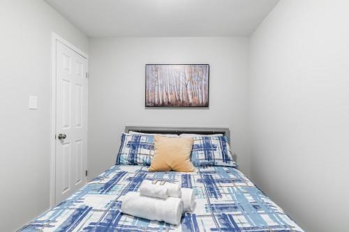 a bedroom with a bed with towels on it at 1BR Basement Condo - James Street in Hamilton