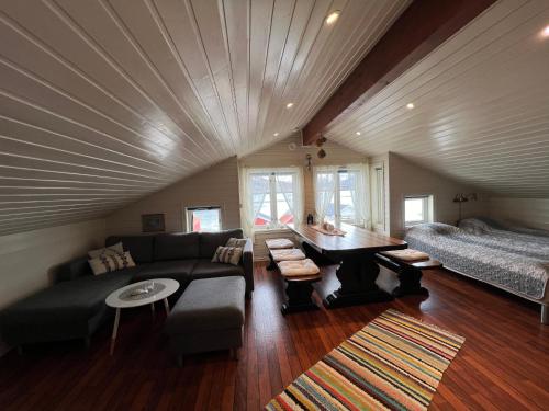 a living room with a couch and a bed at Visit Leif at Senja in Gibostad