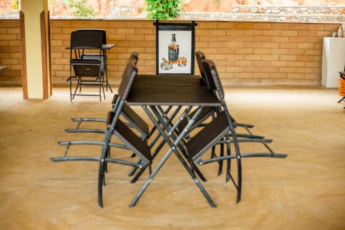 a black table and chairs in a room at Capital Resort Inn in Monaragala