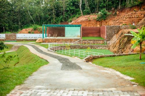 a stone path leading to a building on a hill at Capital Resort Inn in Monaragala